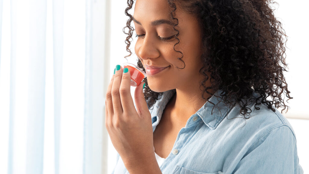 Girl smelling a wax melt sample