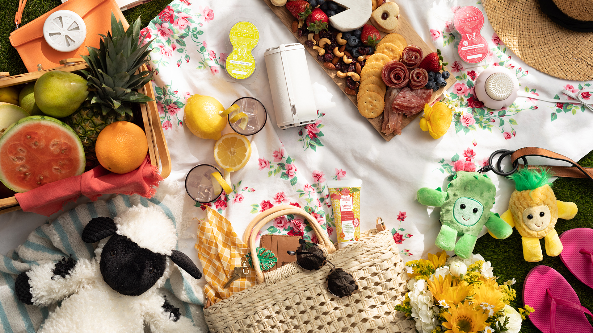 Summer picnic full of scentsy portable scent products, fruits and a charcuterie board on a floral white linen