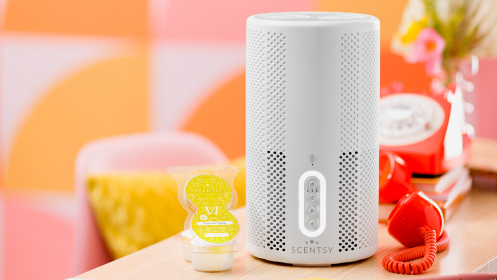 Scentsy air purifier sitting on a table entry way with scentsy pods in pineapple mango fragrance