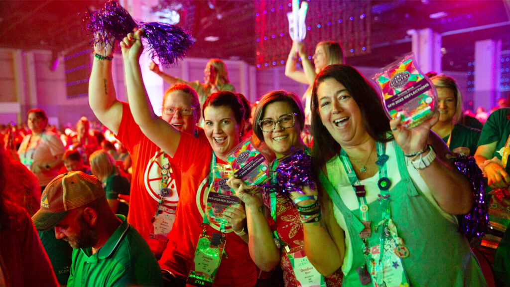 Scentsy consultants cheering and celebrating during the SFR ceremony showing off what they won in the giveaway