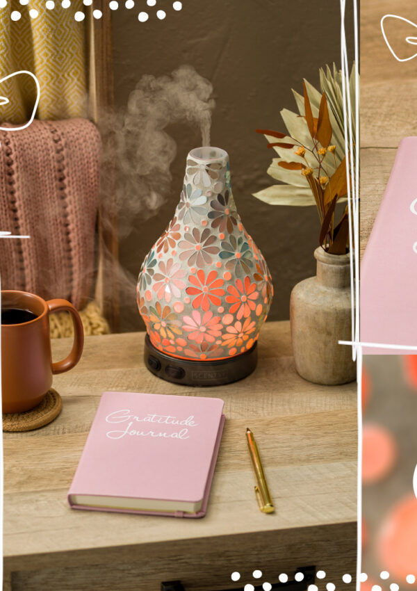 A photo collage of a light pink gratitude journal, a woman journaling, and a Scentsy diffuser releasing essential oils on a desk beside a cup of coffee, journal, and vase of flowers