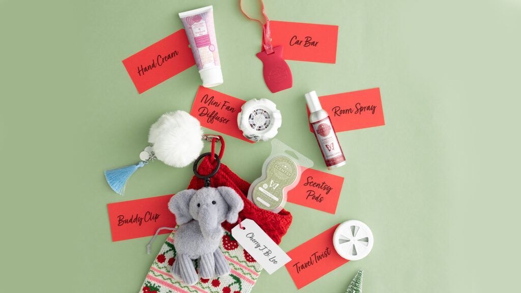 A stocking full of Scentsy products like buddy clips, Scentsy Pods, hand cream, room sprays, travel twists, and mini fan diffusers.