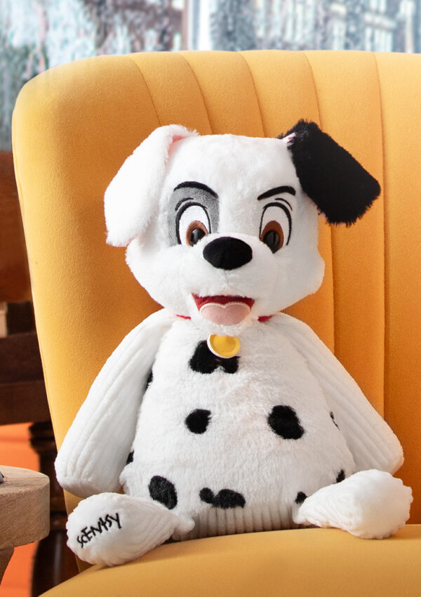 Disney 101 Dalmatians scent products set out on a chair and side table including a wax bar, scent pack and Spot the dog scentsy buddy stuffed animal all inspired by 101 Dalmatians