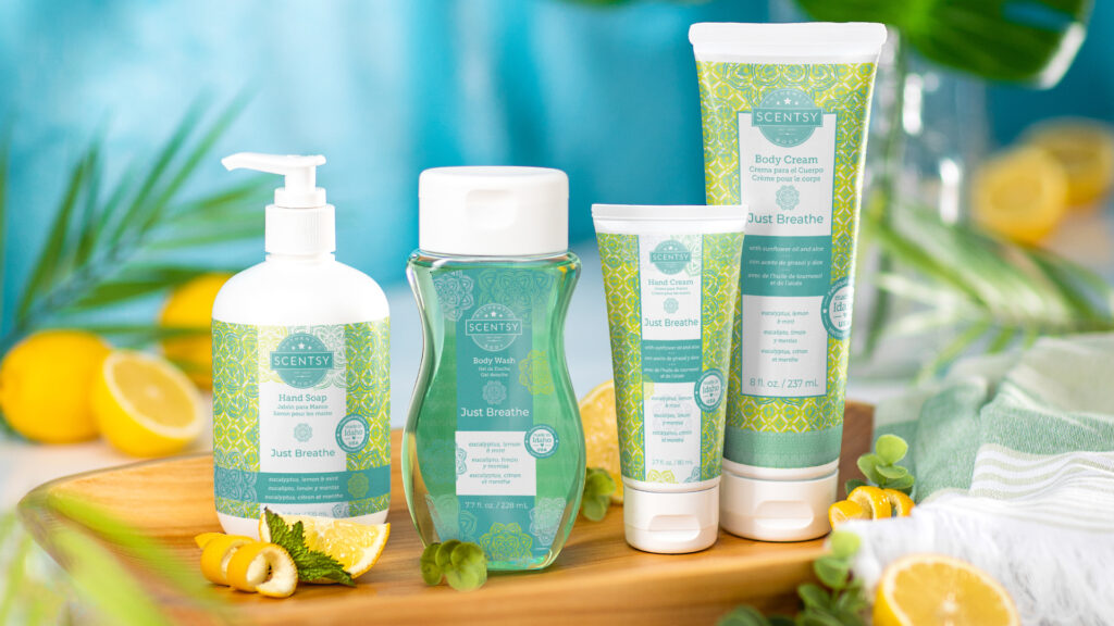 Scentsy body products in just breath fragrance sitting on a wooden board with lemons and other refreshing notes around