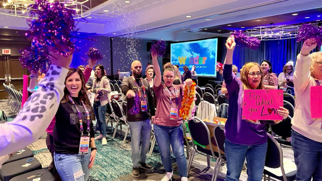 Scentsy consultants at world tour cheering and celebrating their successes with pom poms, confetti and signs