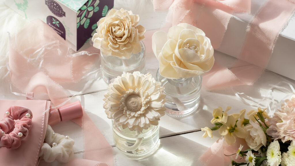 Scentsy Dahlia Darling, Butttercup Belle, and Dainty Daisy fragrance flowers staged together in a wedding table display.