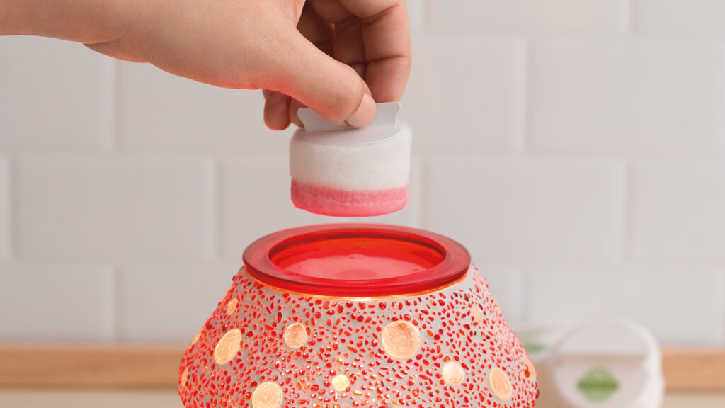 A Scentsy Cotton Cleanup being used to remove the wax from the Cute as A Button wax warmer.