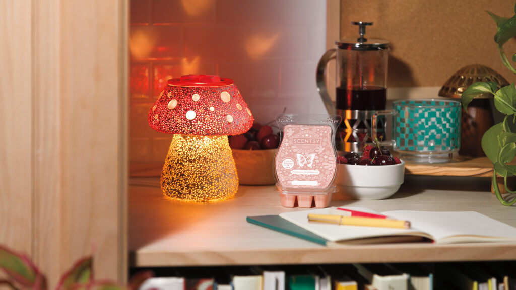 Scentsy Cute as a Button warmer and wax bar glows in the corner of a writing nook.