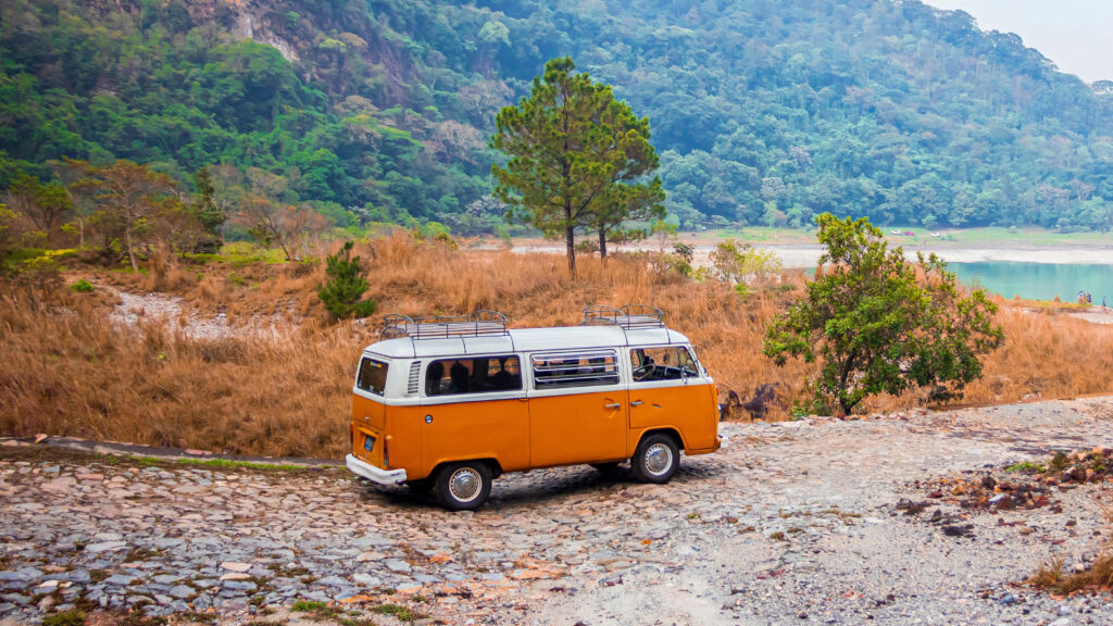 An old VW bus parked on in the wilderness.