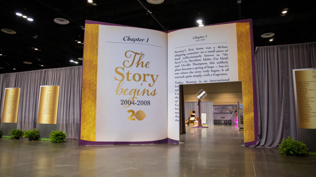 A larger-than-life book depicts the Scentsy story, with a door cut into one page allowing visitors to pass through into the event.