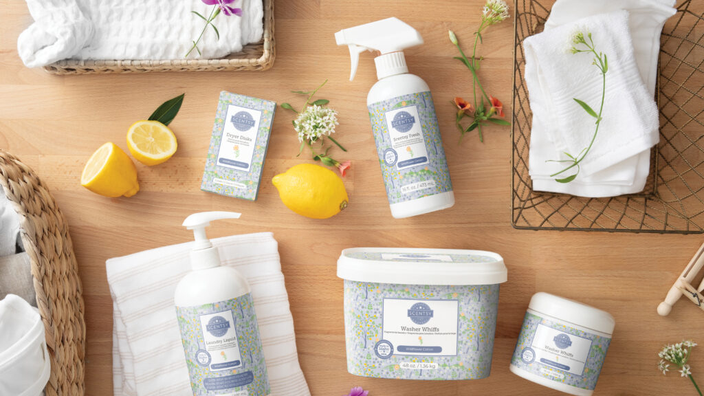 Scentsy laundry products assembled on a table alongside fresh fragrance notes.