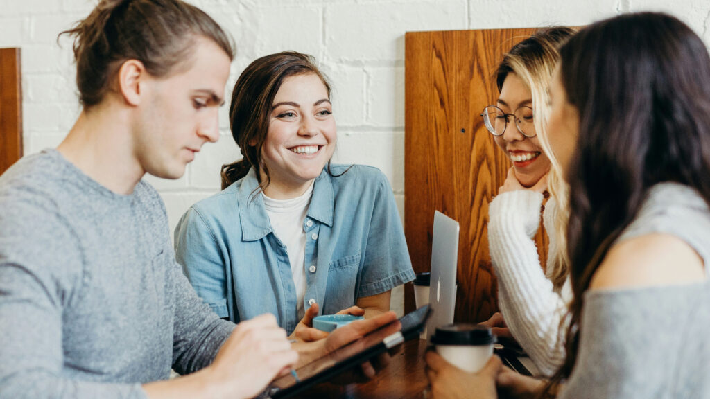 A group of young professionals talking over some coffee.