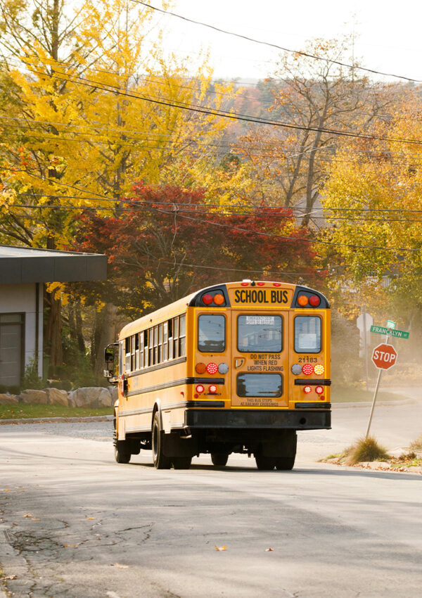 a-school-bus-driving-through-neighborhood