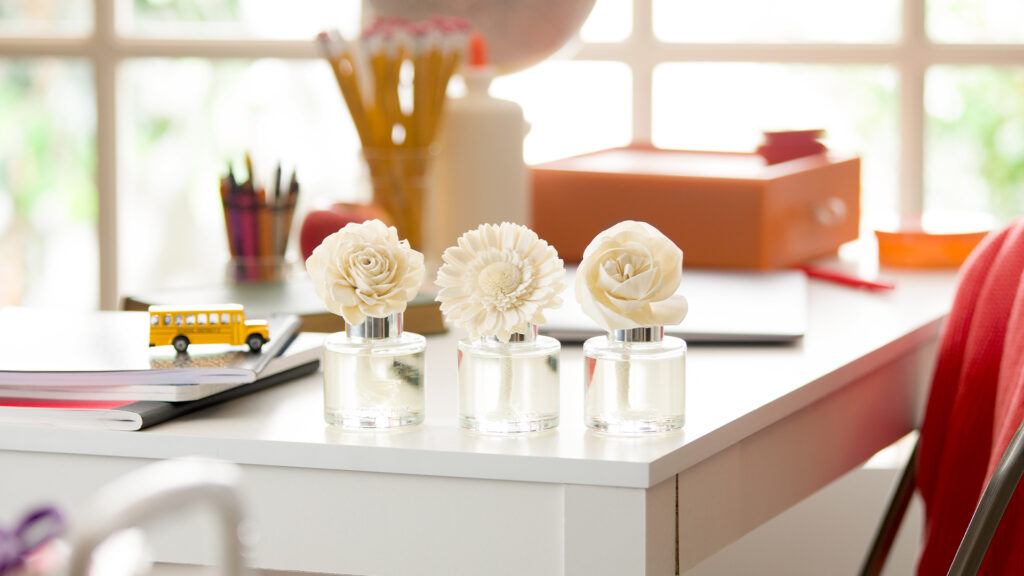 Scentsy Fragrance Flowers sit on a student's study desk.