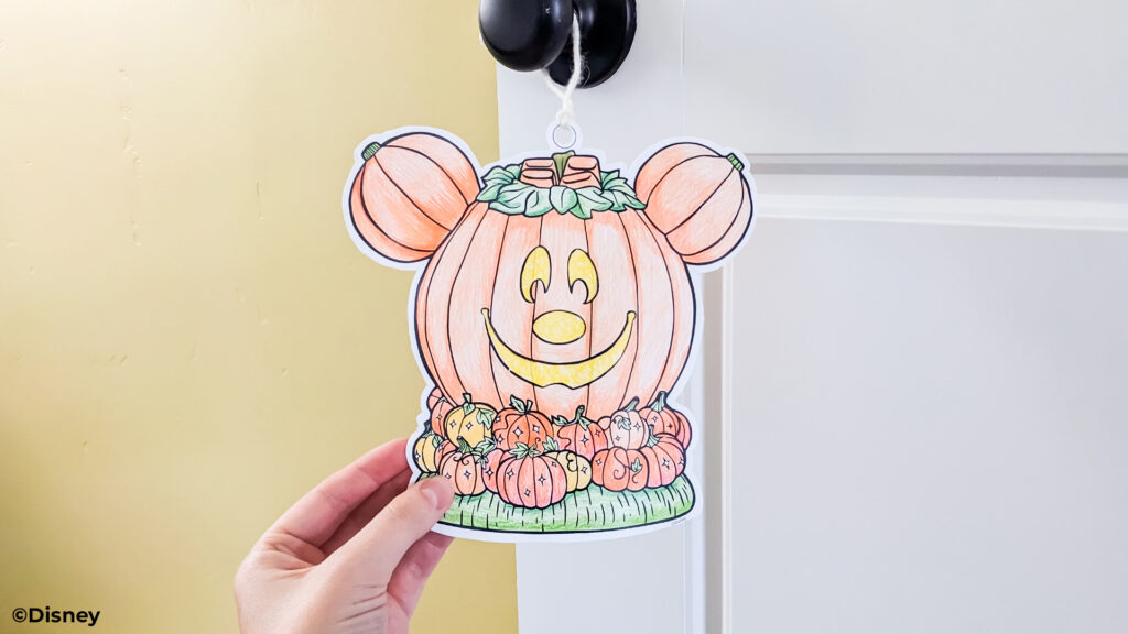 A paper DIY craft door hanger cut out in the shape of the Disney Mickey Mouse Jack-O'-Lantern Scentsy warmer