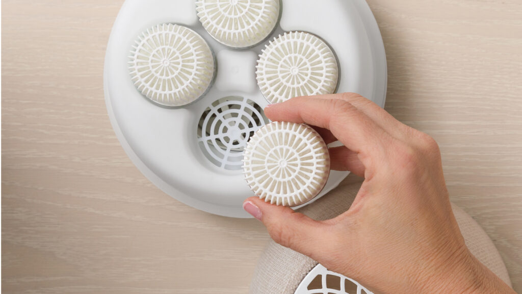 Scents pods being placed into a Scentsy Air.