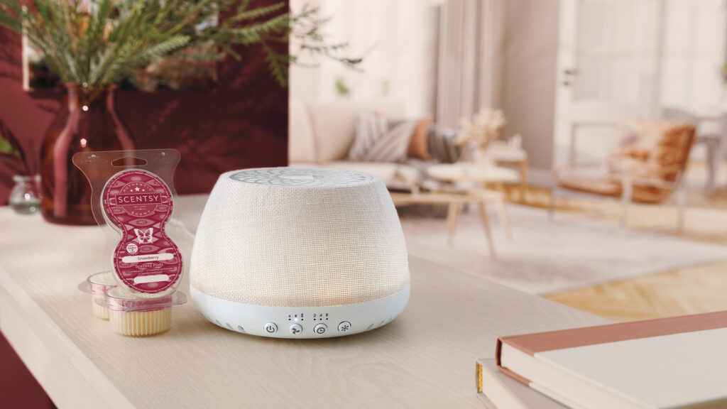 Scentsy Air displayed on a livingroom countertop with Scentsy pods beside it.