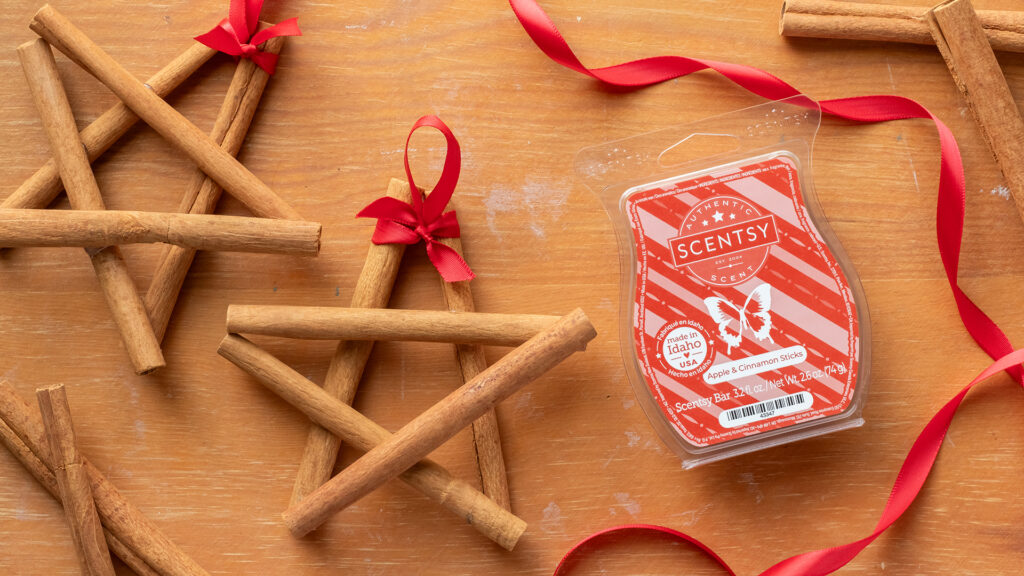 The Scentsy Apple and Cinnamon Sticks Wax Bar next to DIY cinnamon stick Christmas star ornaments.