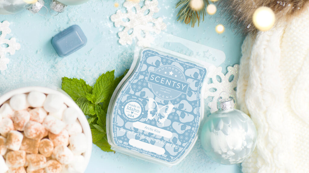 An Artctic Kiss Scentsy Wax Bar pictured surrounded by snowflakes, christmas ornaments, marshmallows, mint to create a fragrant, wintery scene.