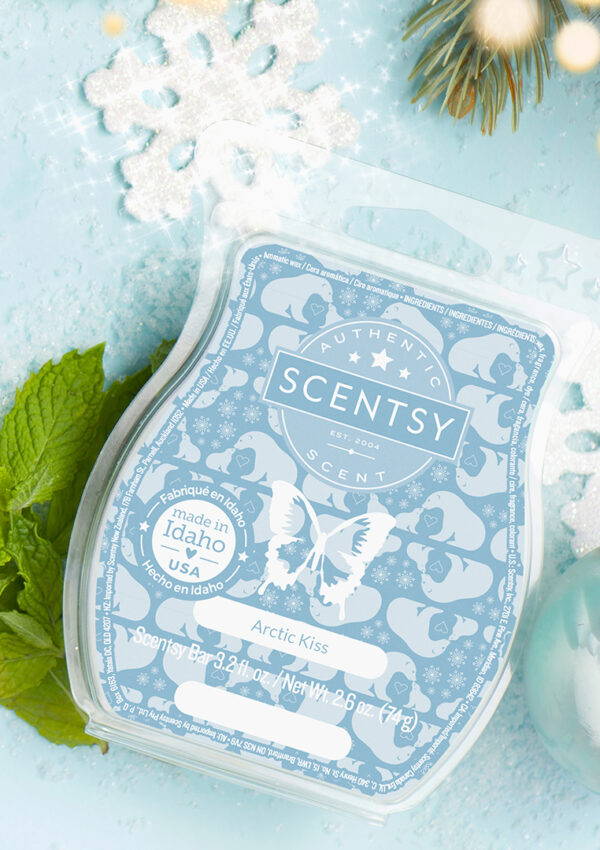 An Artctic Kiss Scentsy Wax Bar pictured surrounded by snowflakes, christmas ornaments, marshmallows, mint to create a fragrant, wintery scene.