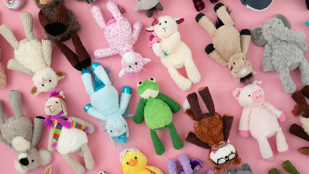 Dozens of Scentsy buddies all layed out next to each other on a pink background.