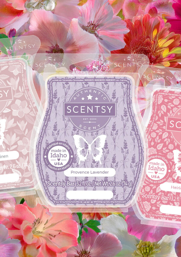 Five Scentsy Wax Bars in floral fragrances sit on a bed of flower petals.