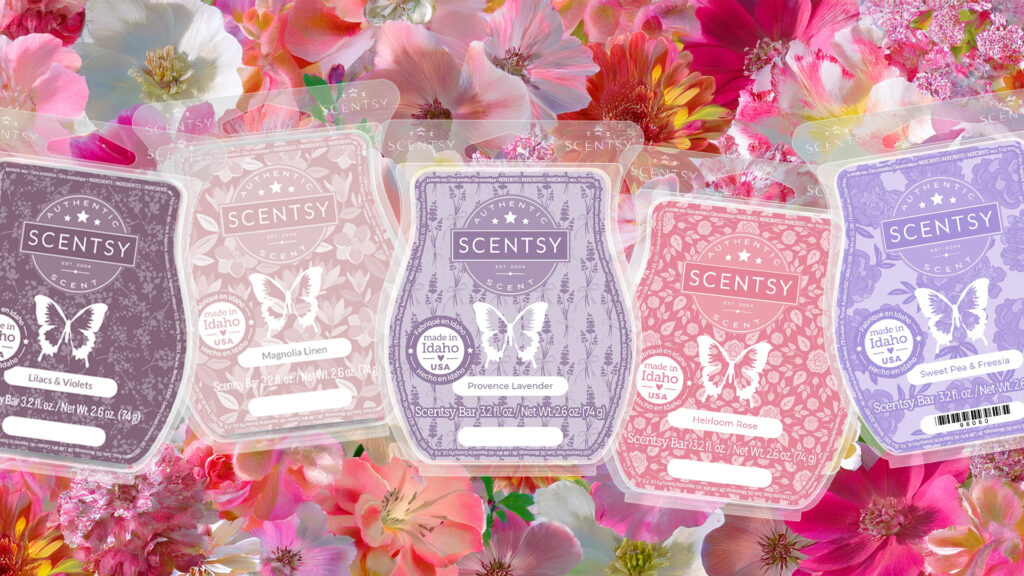 Five Scentsy Wax Bars in floral fragrances lay on a bed of flower petals.