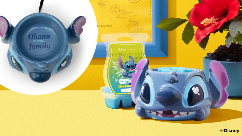 The Disney Stich: warm Fuzzies Scentsy Warmer with the Experiment 626 Scentsy Wax bar, posed on a yellow table with yellow background and a red blossomed hibiscus beside it.