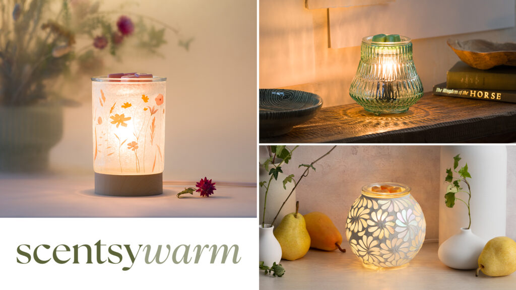 Several elegant, glass Scentsy Warmers from the Scentsy Warm product line are depicted on tables and counter tops radiating warm glows.