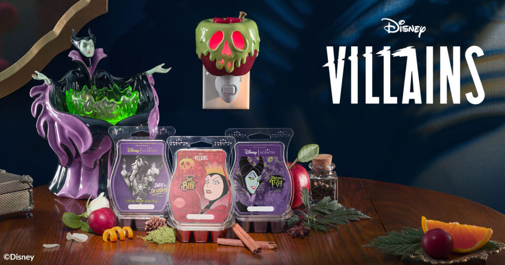 Scentsy Wax Bars Disney Maleficent: Mistress of Evil, Disney Evil Queen: just one bite, and Disney Villains: Dark and Devious, sit on a table with the Maleficent: Made for Mayhem Warmer and Just One Bite Mini-Warmer shaped like the old witch's poisoned apple from Snow White.