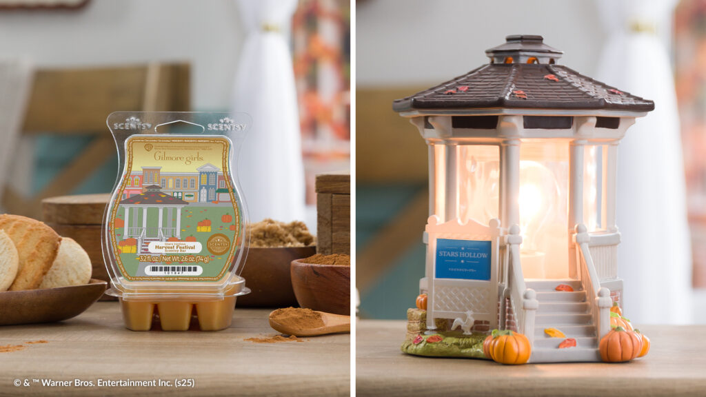 The Gilmore Girls Stars Hollow Festival Wax Bar, with orange wax melt cubes and a label depicting an illustration of Gilmore Girls Star's Hollow and the famous white gazebo, sits surrounded by pastries, bowls of cinnamon, and a wooden spoon. Beside it sits the Welcome to Stars Hollow Scentsy Warmer, shaped to look like iconic the white painted gazebo from Gilmore Girls TV show.