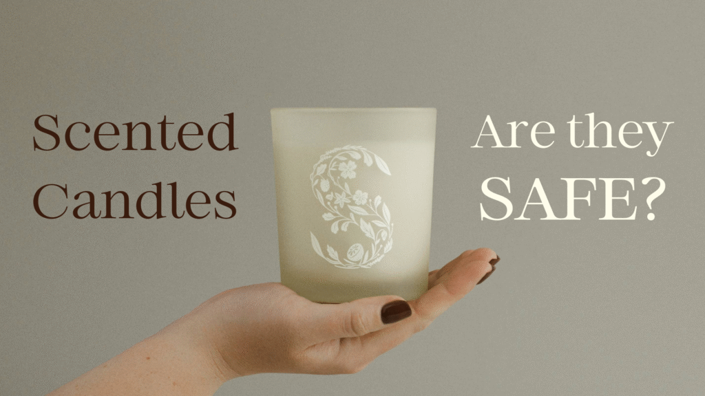 A hand holds a Scentsy candle with a monogrammed S on the glass. To the right and left of the candle, text reads "Scented Candles: are they safe?"