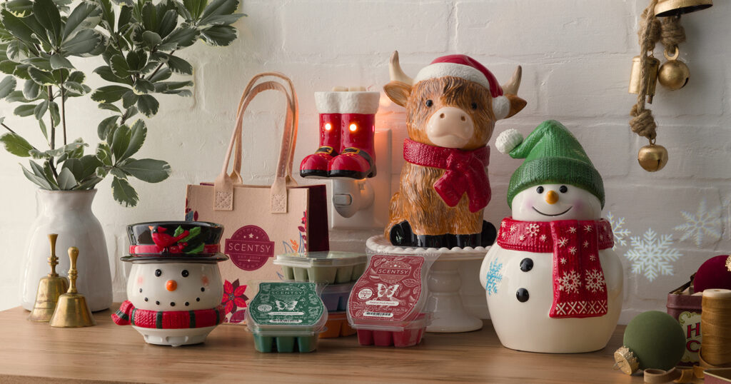 Festive, Christmas-themed warmers, mini warmers, and wax bars in the shapes of highland cows, snowmen, and santa boots all from the Scentsy Holiday Collection.