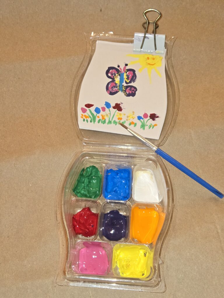 A Scentsy Wax Bar clamshell reused to create a DIY paint set for watercolors or gauche paints.