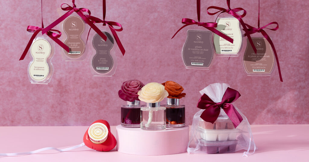 Scentsy Valentine's Day collection Air Pods, Wax Bars bundles, Fragrance Flowers, and Mini Diffusers displayed on a pink background and wrapped with ribbons. 