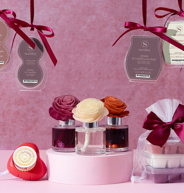 Scentsy Valentine's Day collection Air Pods, Wax Bars bundles, Fragrance Flowers, and Mini Diffusers displayed on a pink background and wrapped with ribbons.