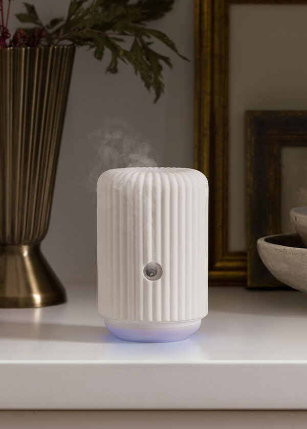 The Scentsy Solo diffuses fragrance on a home kitchen counter.