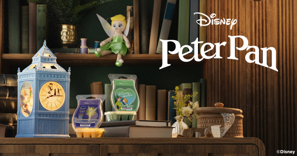 Scentsy's Disney Peter Pan Collection products decorate a themed fantasy bookshelf.