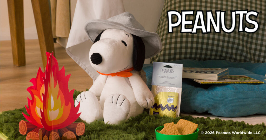 A Snoopy™ Beagle Scouts – Scentsy Buddy is ready for indoor camping with a fake fire and scout hat.