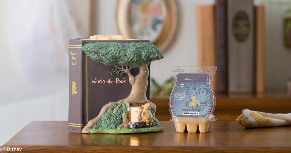 The Disney Winnie the Pooh: 100 Years of Friendship – Scentsy Warmer, full of hand-painted details, is displayed on a console table with a Scentsy wax melt Bar.