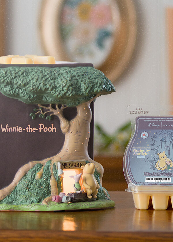 The Disney Winnie the Pooh: 100 Years of Friendship – Scentsy Warmer, full of hand-painted details, is displayed on a console table with a Scentsy wax melt Bar.